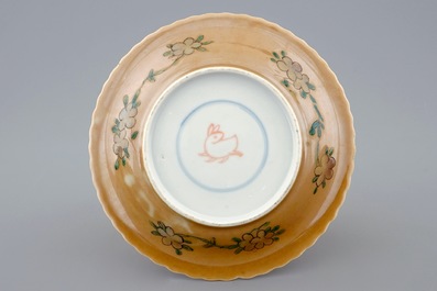 A Chinese famille verte and caf&eacute; au lait cup and saucer, Kangxi